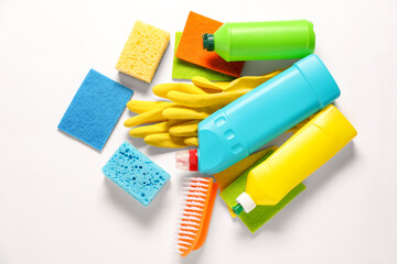 Different cleaning products and tools on white background, flat lay