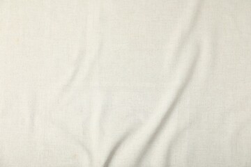 Texture of beige crumpled tablecloth as background, top view