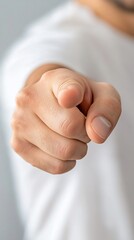 Naklejka premium Man pointing finger, close-up, grey background