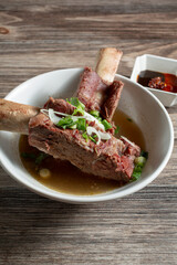 A view of a bowl of beef back ribs.