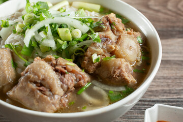A closeup view of a bowl of pho oxtail.