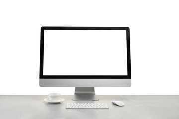 Fototapeta premium Computer monitor, keyboard, mouse and cup of drink on grey desk against white background
