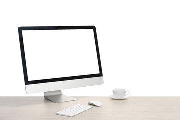 Fototapeta premium Computer monitor, keyboard, mouse and cup of drink on wooden desk against white background