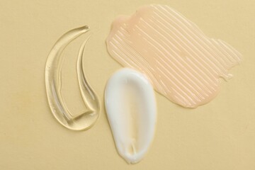 Samples of different cosmetic products on beige background, flat lay