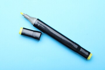 One double sided marker on light blue background, top view