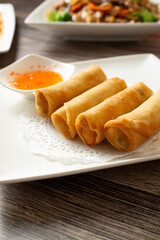 A view of a plate of egg rolls.
