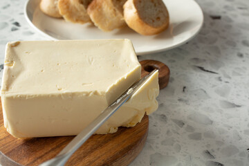 A view of a knife cutting into a block of dairy-free butter.