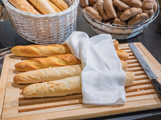 The basis of a Swedish breakfast in hotels - French baguette and a bread knife are prepared for...