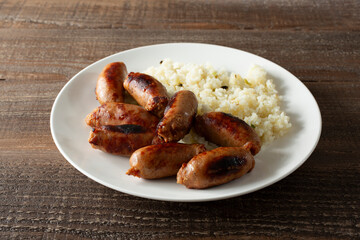 A view of a plate of longanisa sausage and garlic rice.