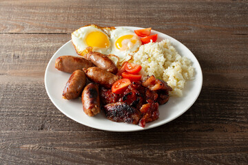 A view of a plate of tocino, longanisa, and garlic rice.