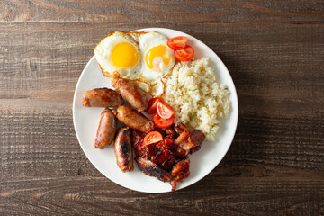 A top down view of a plate of tocino, longanisa, and garlic rice.