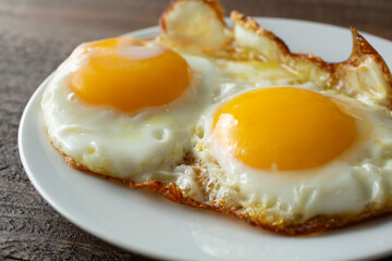A closeup view of a plate of fried eggs.