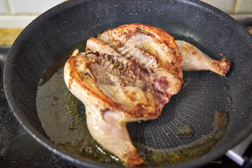 there's a fried chicken in a skillet on the stove