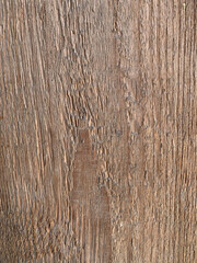 Aged wooden surface with a rough texture, deep grain patterns, and natural imperfections, highlighting rustic character
