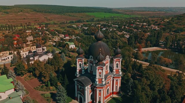 Curchi Monastery. A stunning aerial view beautifully captures a historic church nestled amidst vibrant greenery and idyllic rural scenery