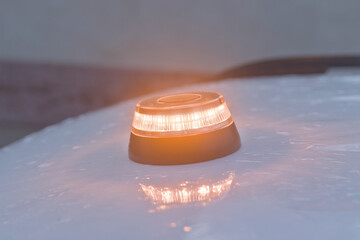 
v-16 emergency light on top of a vehicle on a rainy day