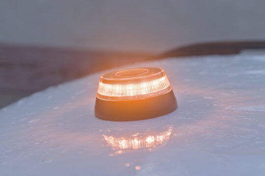 
v-16 emergency light on top of a vehicle on a rainy day