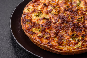 Delicious fresh quiche with broccoli, cheese, spices and herbs