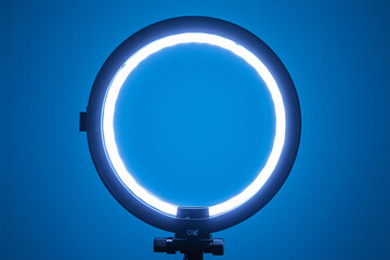 Ring light illuminating a cozy streaming setup with blue background and adjustable stand for optimal lighting