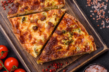 Delicious fresh quiche with broccoli, cheese, spices and herbs