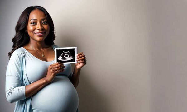 African american Pregnant woman shows a 3D ultrasound image of her unborn child. Copy space for text background