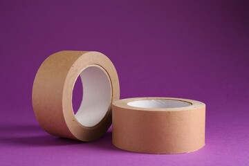 Rolls of masking tapes on violet background