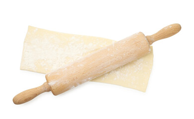 Fresh dough and rolling pin isolated on white, top view