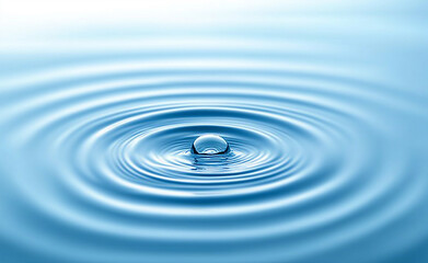 A water droplet captured in mid-air just before making contact with the surface, creating ripples.