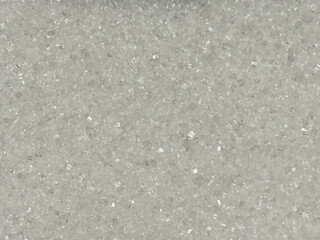 A background of sugar crystals, creating a shiny texture and playful light reflections.