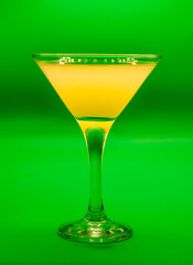 Coctel de color amarillo en una copa.