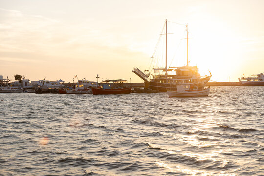 Sunset over the sea with boats and yachts on Paros Island, Greece. 