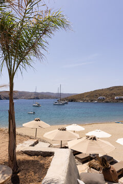 Clear sky and sunny day with blue waters and boats surrounding the sand on Agistri in Greece.
