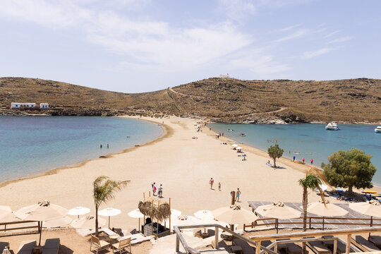 Clear sky and sunny day with blue waters and boats surrounding the sand on Agistri in Greece.