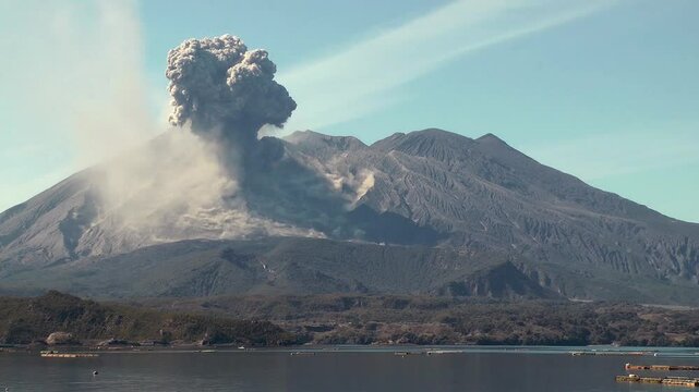 View over sea of an ash cloud eruption from Sakurajima volcano, Indonesia.