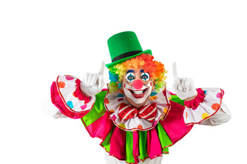 Funny clown pointing up at blank template copy spase for advertising, posters, greetings, invitations. Entertainer as Joker in a suit and wig, with clown whiteface makeup.