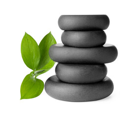Fototapeta premium Stacked spa stones and green leaves isolated on white