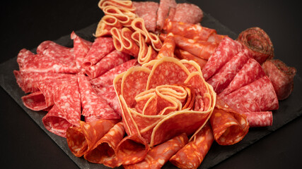 Different kinds of meat cuts on a board.