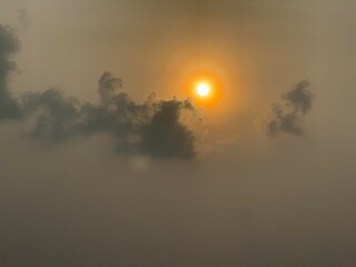 Sunset clouds and rings around sun
