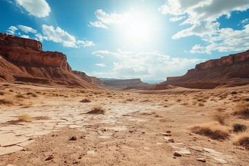 Naklejka premium Arid Desert Landscape with Cracked Dry Earth and Barren Wasteland Under a Harsh Sunlit Sky