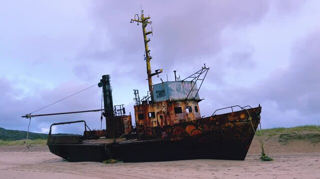 Teriberka, September 5, 2023: View of an abandoned ship on the coast of the Barents Sea in Teriberka. Autumn tundra. The sandy coast of the Barents Sea. Landscapes of the Russian North.  4К