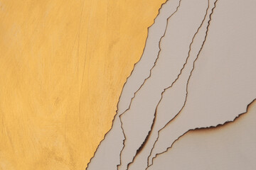 Burned  Torn, ripped paper pieces wave lines. Gold, Beige, brown copy space texture background