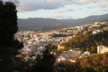 top view of other side of malaga with lots of big residential buildings close to the forest and hills, also seen the mountain the backgournd