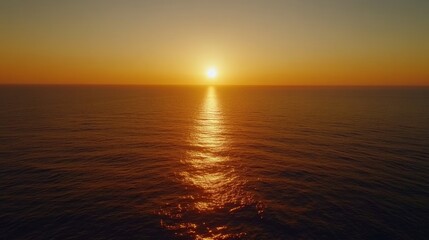 Obraz premium Serene Sunset Over Calm Ocean Waves With Golden Reflection