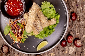 Snack made from fried sticks: top view with chestnuts on textured background