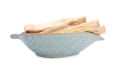 Palo santo sticks in ceramic bowl on white background