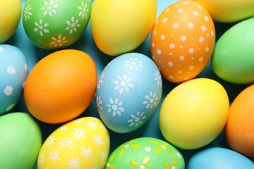 Beautiful decorated Easter eggs on light blue background, top view