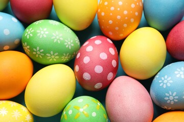 Beautiful decorated Easter eggs on light blue background, top view