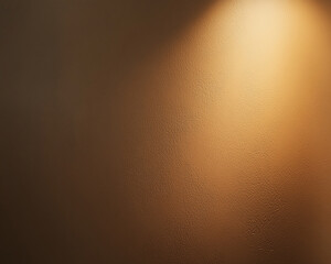 A close-up of a textured wall with soft lighting shining from the top, casting shadows and creating a warm, ambient atmosphere. This image evokes a sense of calm and serenity.