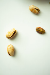 Close up of pistachios on a white background