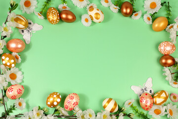 Abstract spring easter composition with golden painted eggs, feathers, butterflies, blossom branches and flowers. Happy easter concept. Screen banner with space for greeting text
